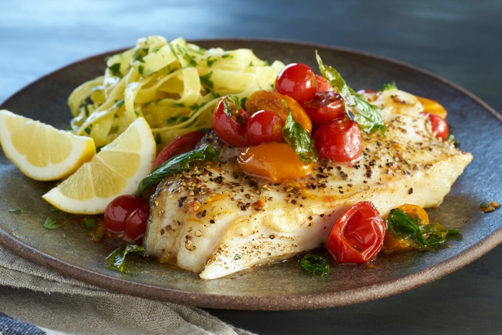 Seared halibut steaks with cherry tomatoes and basil